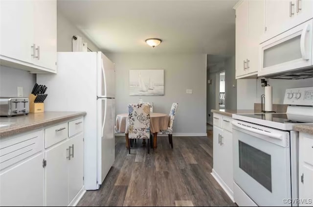 kitchen with dark hardwood / wood-style flooring, white cabinetry, and white appliances