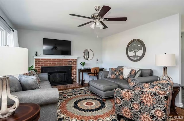 living room featuring a fireplace, hardwood / wood-style floors, and ceiling fan