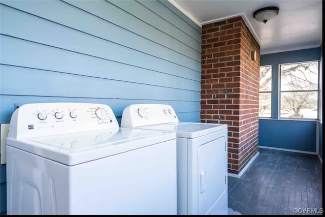 clothes washing area featuring wood walls, dark hardwood / wood-style floors, and independent washer and dryer