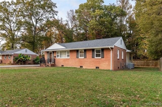 view of front of home with central AC and a front lawn