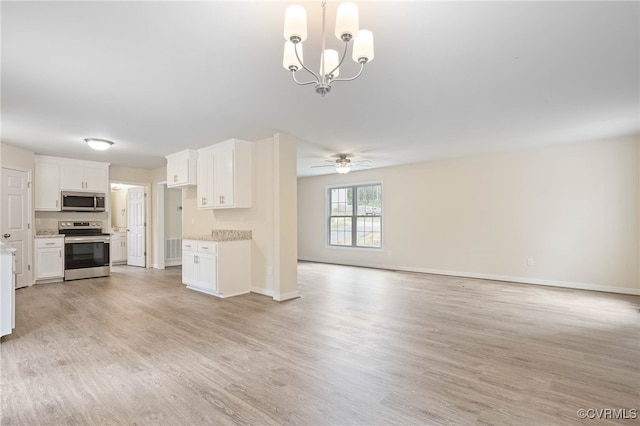 interior space featuring stainless steel appliances, light hardwood / wood-style floors, white cabinetry, ceiling fan with notable chandelier, and hanging light fixtures