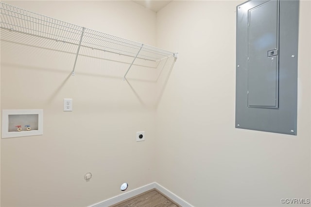 clothes washing area with electric panel, wood-type flooring, electric dryer hookup, hookup for a gas dryer, and hookup for a washing machine