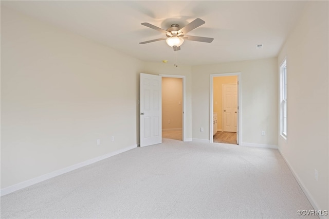 unfurnished room featuring light carpet and ceiling fan