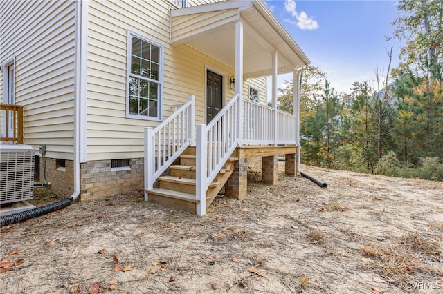 entrance to property with cooling unit and a porch