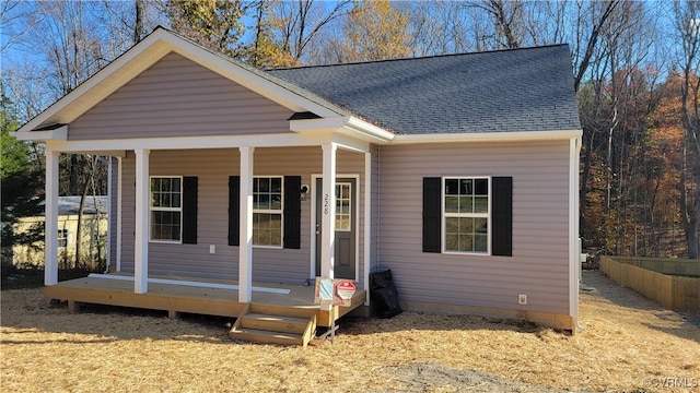 view of front of home with covered porch and roof with shingles