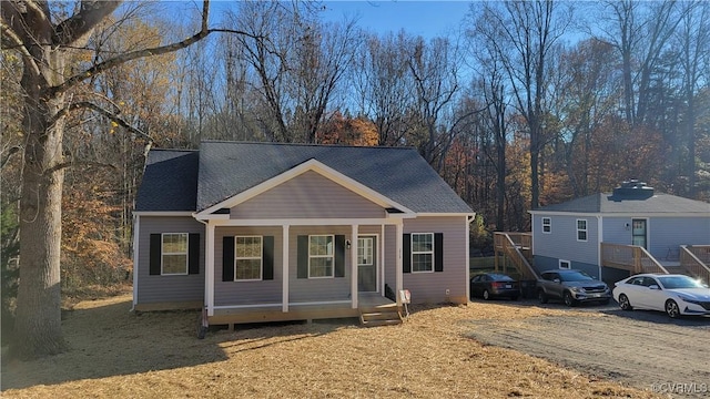 view of front of property with a porch and a shingled roof