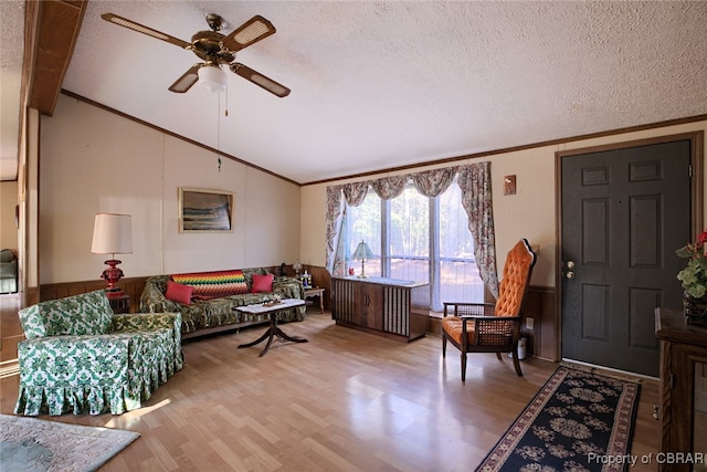 living room with hardwood / wood-style floors, lofted ceiling with beams, and a textured ceiling