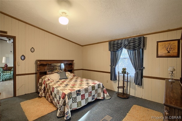 bedroom with carpet flooring, crown molding, and a textured ceiling