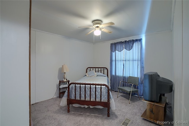 bedroom featuring carpet flooring, ceiling fan, and crown molding