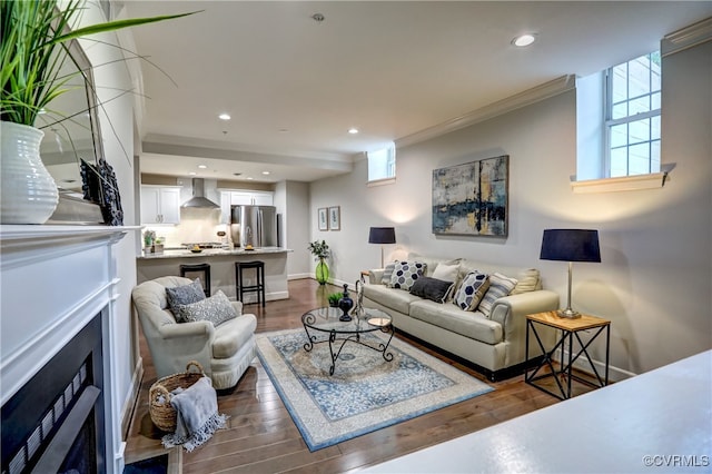 living room featuring wood-type flooring and crown molding