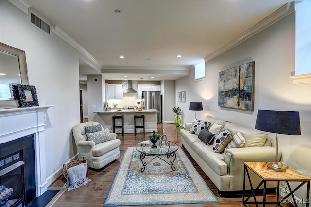 living room featuring crown molding and dark hardwood / wood-style flooring