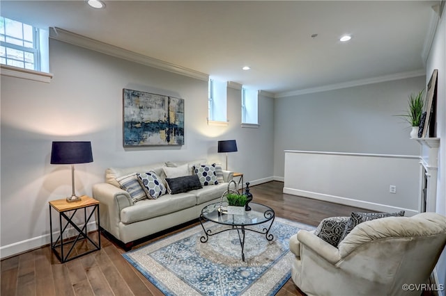 living room featuring hardwood / wood-style floors, a fireplace, and ornamental molding