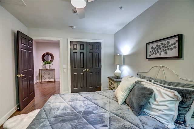 bedroom featuring hardwood / wood-style floors, ceiling fan, and a closet