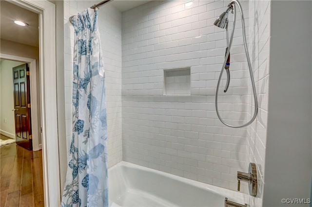 bathroom featuring shower / bath combo with shower curtain and wood-type flooring