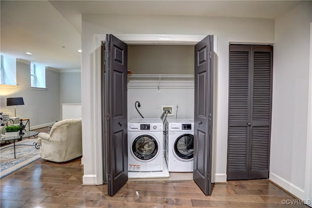 washroom with hardwood / wood-style flooring and washer and dryer