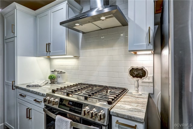 kitchen with white cabinetry, backsplash, wall chimney exhaust hood, and stainless steel appliances