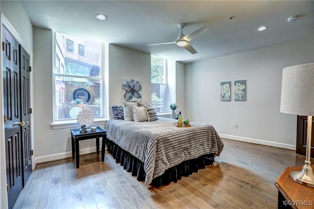 bedroom with a closet, wood-type flooring, and ceiling fan