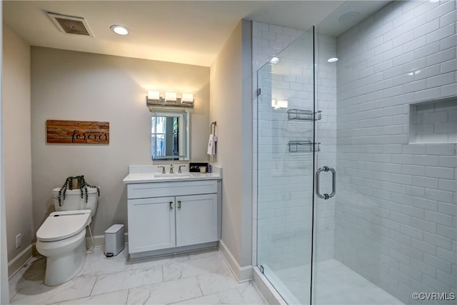 bathroom with toilet, vanity, and walk in shower