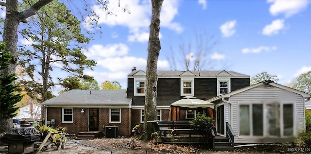 rear view of property featuring central AC