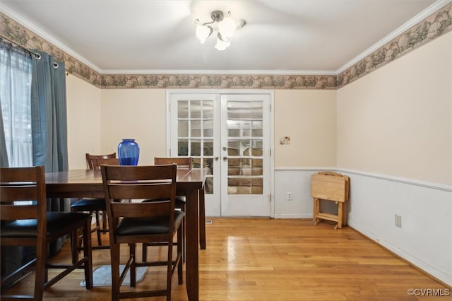 dining area featuring crown molding, french doors, and light hardwood / wood-style floors