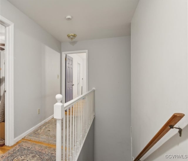 corridor with hardwood / wood-style flooring