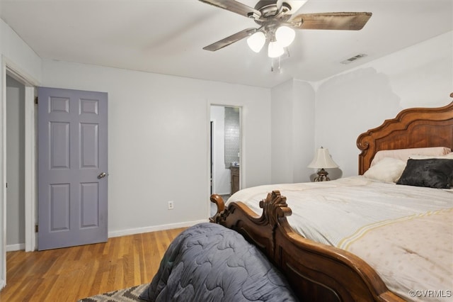 bedroom featuring ensuite bath, ceiling fan, and light wood-type flooring