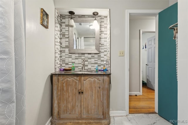 bathroom featuring backsplash, curtained shower, hardwood / wood-style floors, and vanity