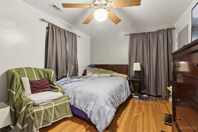 bedroom with ceiling fan and light hardwood / wood-style flooring