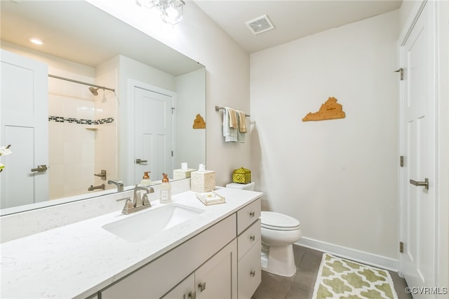 full bathroom featuring vanity, tile patterned flooring, toilet, and tiled shower / bath combo