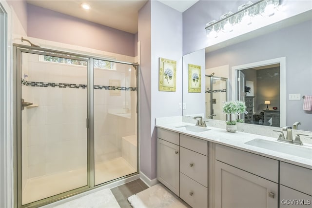 bathroom featuring an enclosed shower, wood-type flooring, and vanity