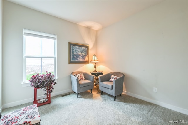 living area featuring carpet