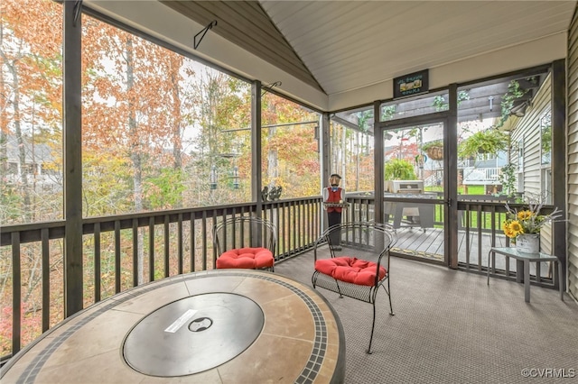 sunroom with wood ceiling and lofted ceiling