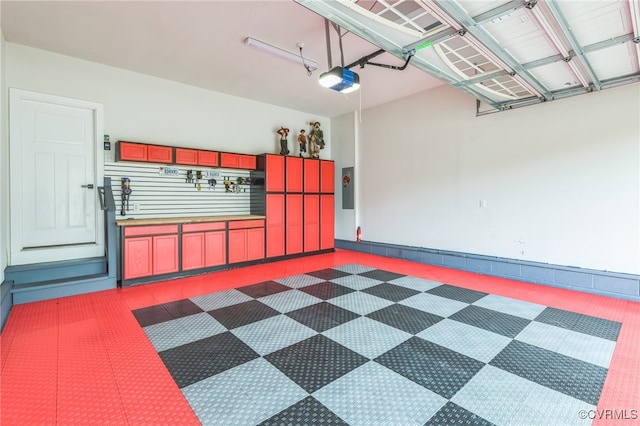 garage featuring a garage door opener and electric panel