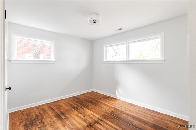 unfurnished room featuring hardwood / wood-style flooring