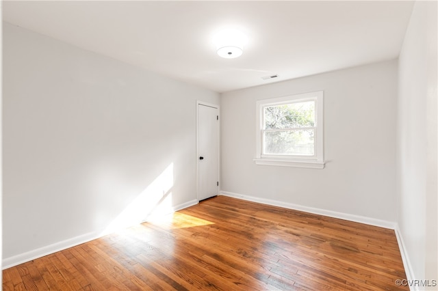 empty room with hardwood / wood-style floors