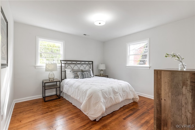 bedroom with hardwood / wood-style flooring