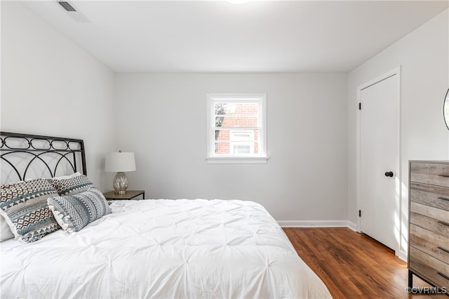 bedroom featuring dark hardwood / wood-style flooring