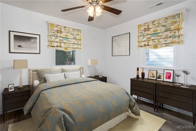 bedroom with ceiling fan and dark hardwood / wood-style floors