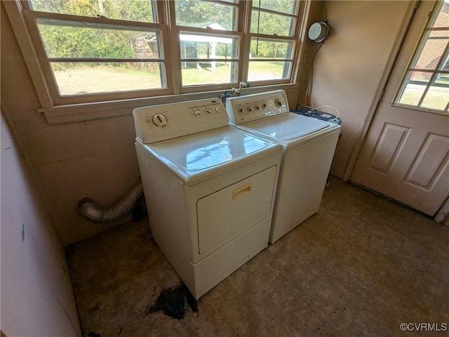 laundry area featuring a wealth of natural light and independent washer and dryer