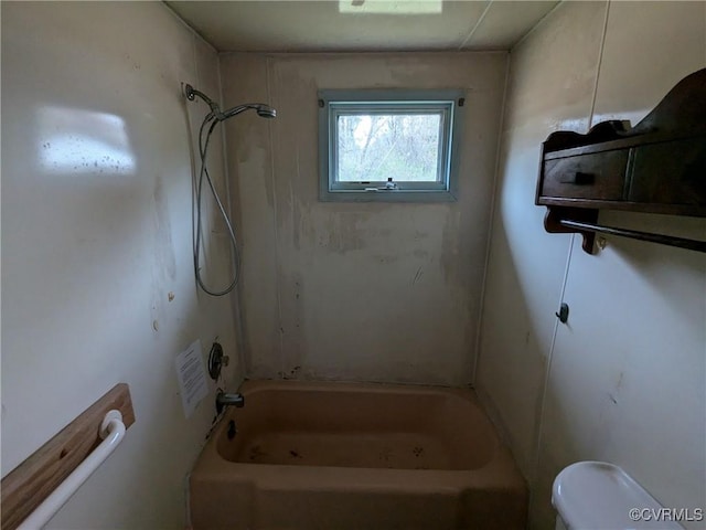 bathroom with bathtub / shower combination and toilet