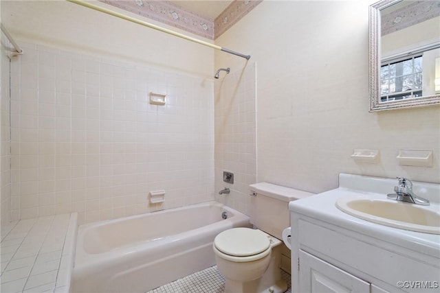 full bathroom with tile patterned floors, vanity, toilet, and tiled shower / bath combo