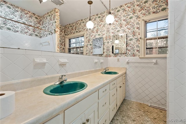 bathroom with tile patterned flooring, vanity, and tile walls