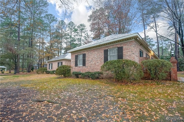 view of side of home with a lawn