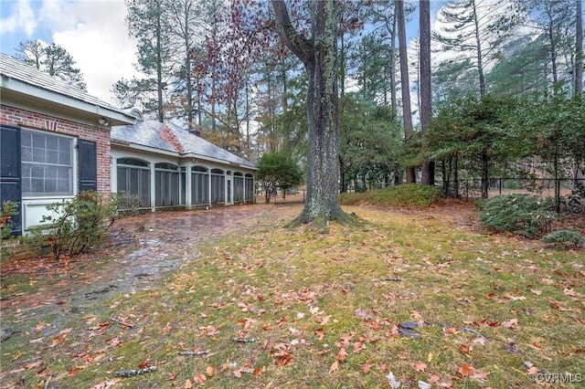 view of yard featuring a sunroom