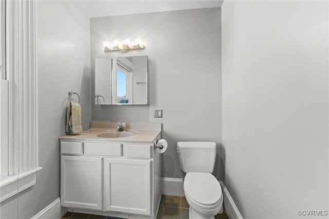 bathroom featuring vanity, toilet, and tile patterned floors