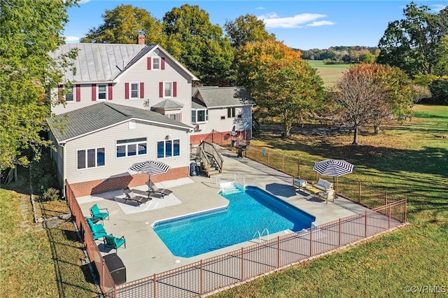 view of swimming pool with a lawn and a patio area