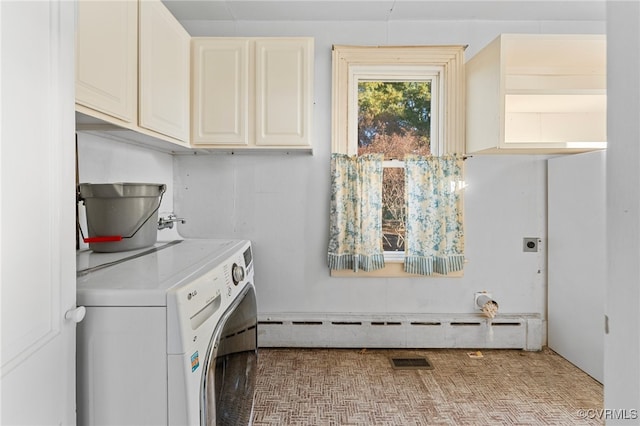 laundry room with washer / clothes dryer, a baseboard heating unit, and cabinets