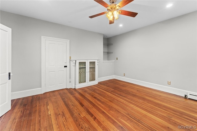 unfurnished room with ceiling fan and dark wood-type flooring