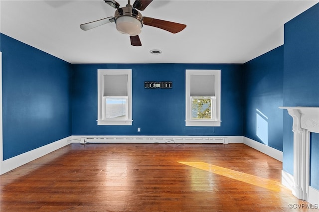 interior space featuring baseboard heating, ceiling fan, and hardwood / wood-style flooring