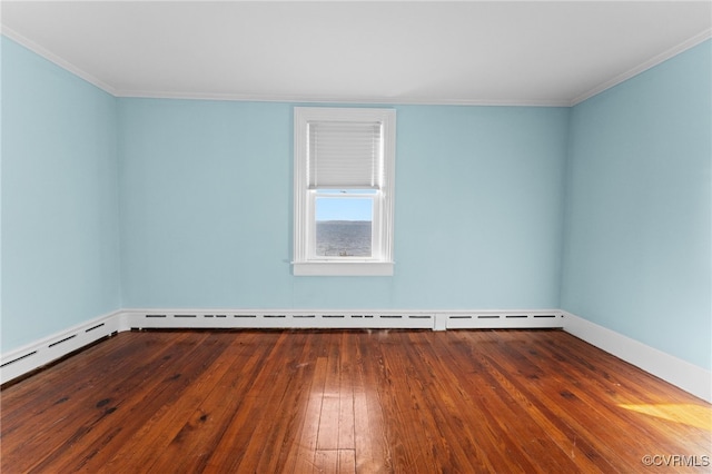 empty room featuring ornamental molding and hardwood / wood-style flooring